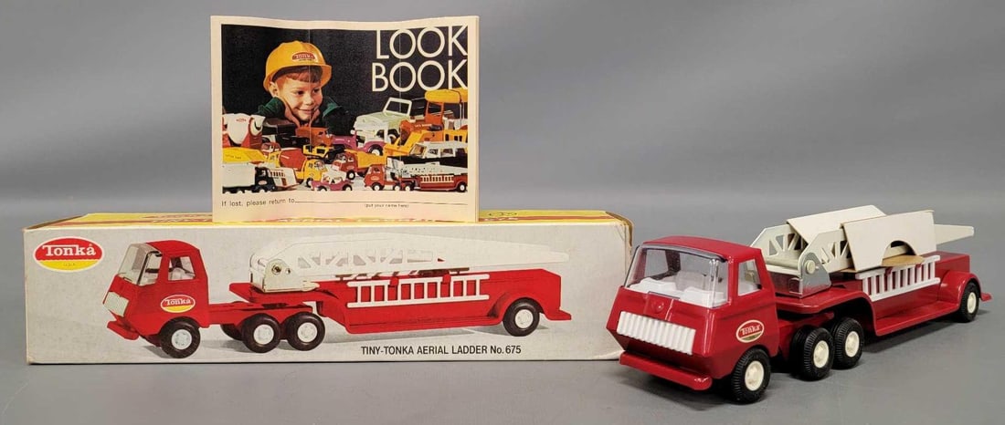 Mint Tiny Tonka pressed steel aerial ladder in original box 675: Mint Tiny Tonka pressed steel aerial ladder in original box, stock number 675. Truck is new old stock in an excellent original box with a crisp look book as seen in the photos.