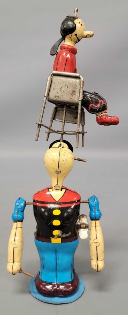 Linemar tin lithographed wind-up Juggling Popeye and Olive Oyl toy: Linemar tin lithographed wind-up Juggling Popeye and Olive Oyl toy in very good to excellent minus condition. Popeye is missing the end of his pipe but that is a common trait as seen in the photos. It