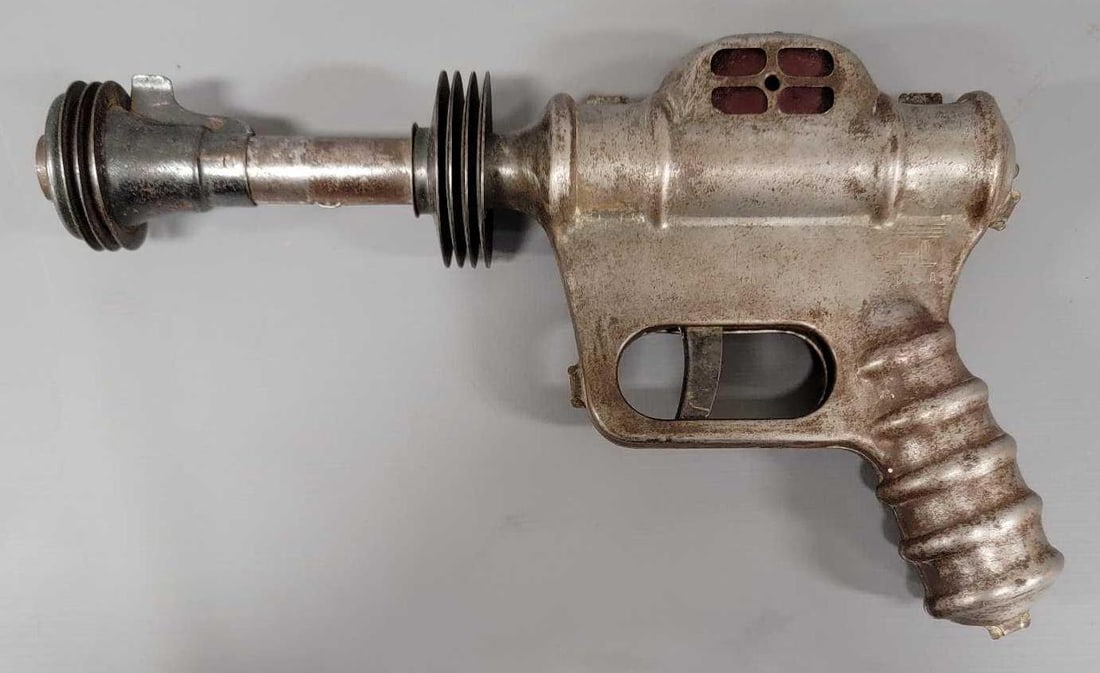 1930's Daisy Buck Rogers U-235 Atomic Pistol with silver finish: 1930s Daisy Buck Rogers U-235 Atomic Pistol with silver finish. It has seen better days but it is what it is. Calling it very good condition, still makes the pop sound and an occasional spark shows th