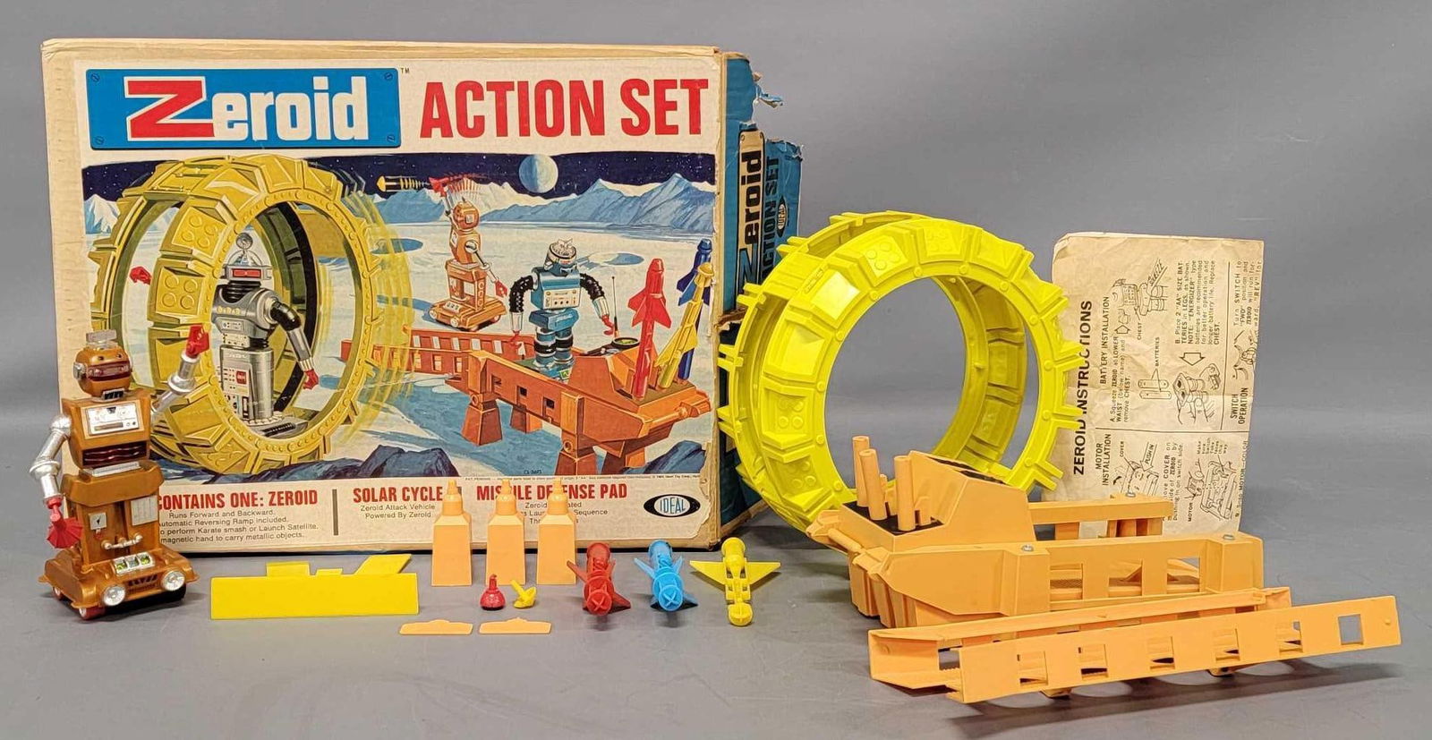 Ideal Zeroid Action Set in original box with plastic Zobor robot: Ideal Zeroid Action Set in original box with plastic Zobor robot. The set has an incomplete Zobor robot due to a missing motor and one rubber track plus tabs on the underside that would hold the black