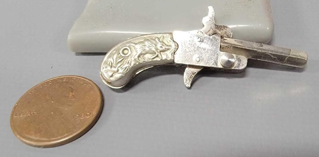 Rare high grade Franz Pfannl boar grip 2mm pinfire pistol: Rare high grade Franz Pfannl boar grip 2mm pinfire pistol. This tiny little guy measures at 1 3/4 inches long and is in exceptional condition. It can be found in The Tiniest Guns written by Bob Urso V