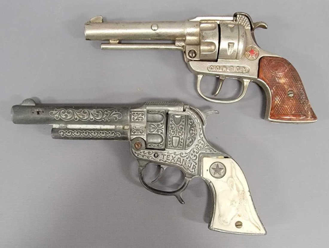 Hubley Texan Jr and Hubley Cowboy cap guns: Hubley Texan Jr die cast and Hubley Cowboy cast iron cap guns, both are in very good to excellent working condition as seen in the photos.