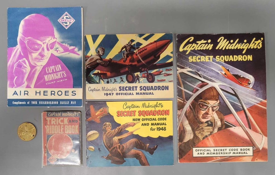 Group of vintage Captain Midnight ephemera and coin: Group of vintage Captain Midnight ephemera and coin to include a Secret Code book, trick and riddle book, unused stamp book and Secret Squadron official manuals for 1947 and 1948 as seen in the photos