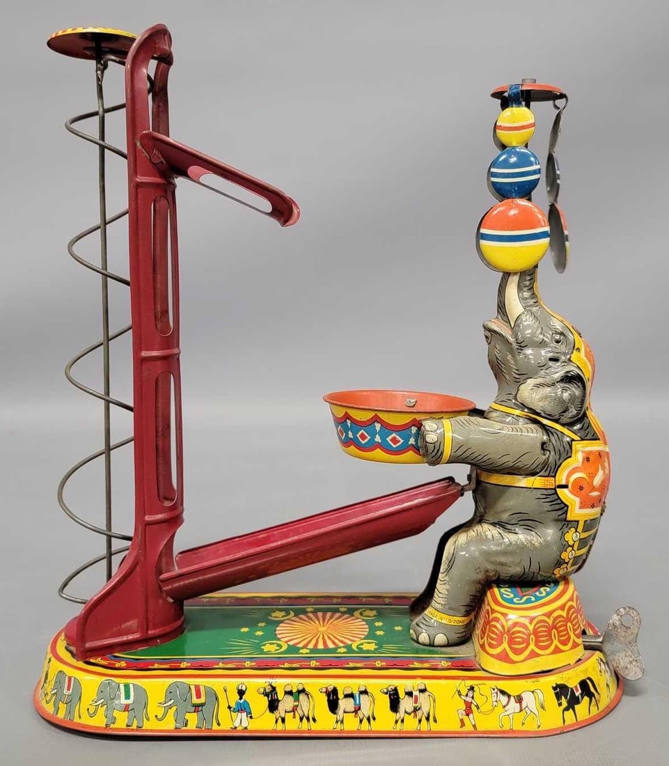 Joseph Wagner in lithographed wind-up US Zone Germany elephant: Joseph Wagner in lithographed wind-up US Zone Germany elephant toy, works great but all three of the colorful balls are missing. Measures 8 1/4 inches long as seen in the photos.