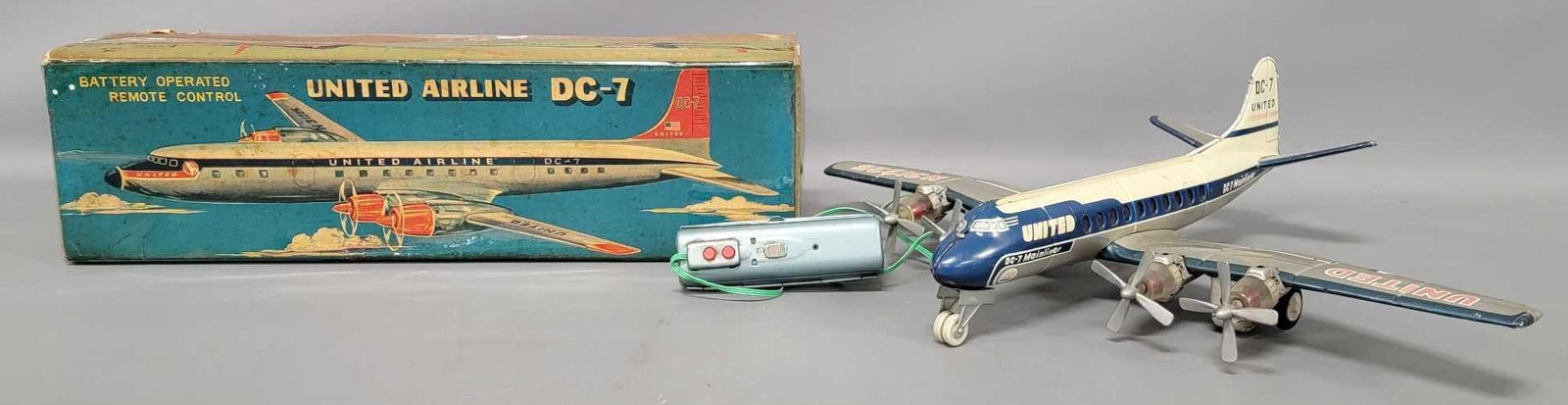 Nomura Japan tin battery operated remote control United Airline DC-7 airplane in OB: Nomura Japan tin battery operated remote control United Airline DC-7 airplane in original box in excellent working condition in a complete original box that is completely covered in tape to prevent an