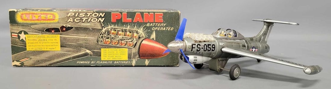 Nomura Japan tin battery operated lited piston action plane in original box: Nomura Japan tin battery operated lited piston action plane in original box in excellent working condition in a very good to excellent original box as seen in the photos. Measures 13 1/2 inches long.