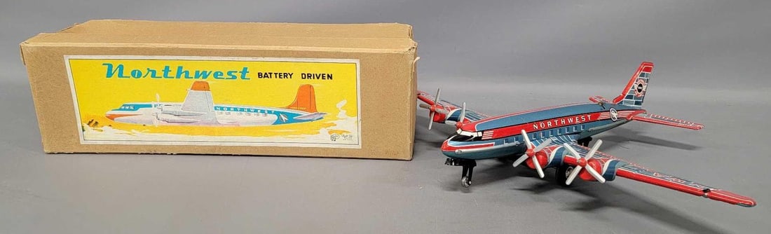 ATC Asahitoy Japan tin battery operated Northwest air liner in original box: ATC Asahitoy Japan tin battery operated Northwest air liner in original box in excellent working condition although the inner left prop spins very slowly. Comes in a very good original box with a grea