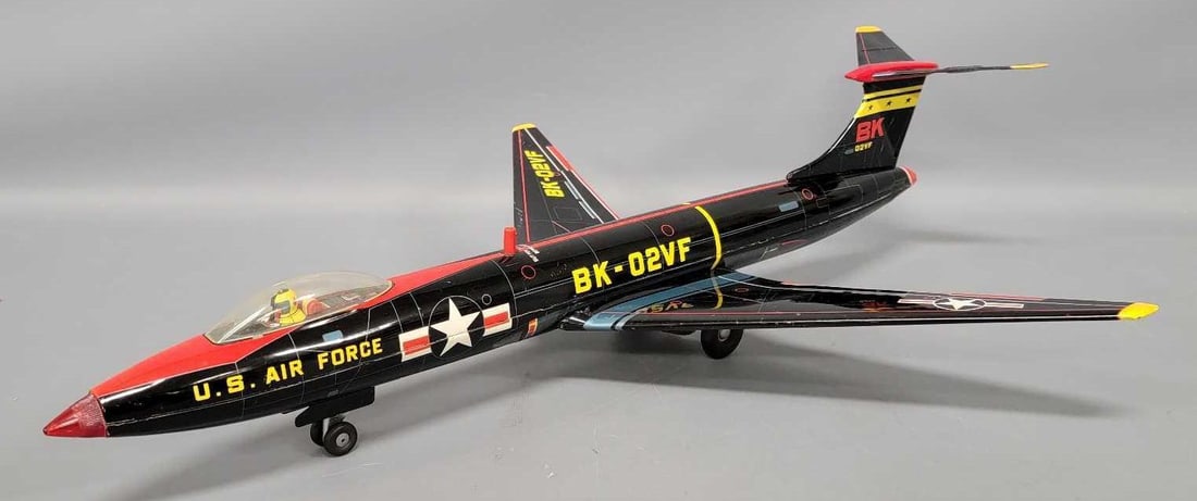 Japan tin lithographed friction BK-02VF US Air Force jet bomber with bomb-bay doors: Japan tin lithographed friction BK-02VF US Air Force jet bomber with bomb-bay doors. It is in excellent condition with a crease on each side of the elevator. The friction does work and the button open