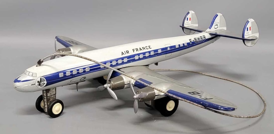 Joustra France tin lithographed Air France Super G battery operated remote control airplane: Joustra France tin lithographed Air France Super G battery operated remote control airplane in excellent condition. The only function is that the wheels power it across the floor and the control steer