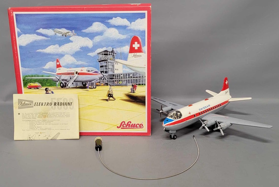 Reproduction Schuco Elektro Radiant 5600 Swiss Air tin lithographed battery operated airplane in OB: Reproduction Schuco Elektro Radiant 5600 Swiss Air tin lithographed battery operated airplane in original box, stock number 00217. The plane is near mint to mint in an excellent original box with orig