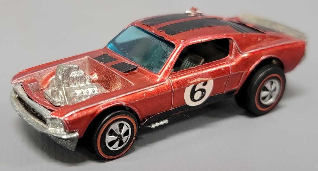 Redline Hot Wheels red Boss Hoss Mustang: Redline Hot Wheels red Boss Hoss Mustang, car is in very good condition with high edge wear, paint chips, roof decals are lifting up on the edges and base is very shiny as seen in photos.
