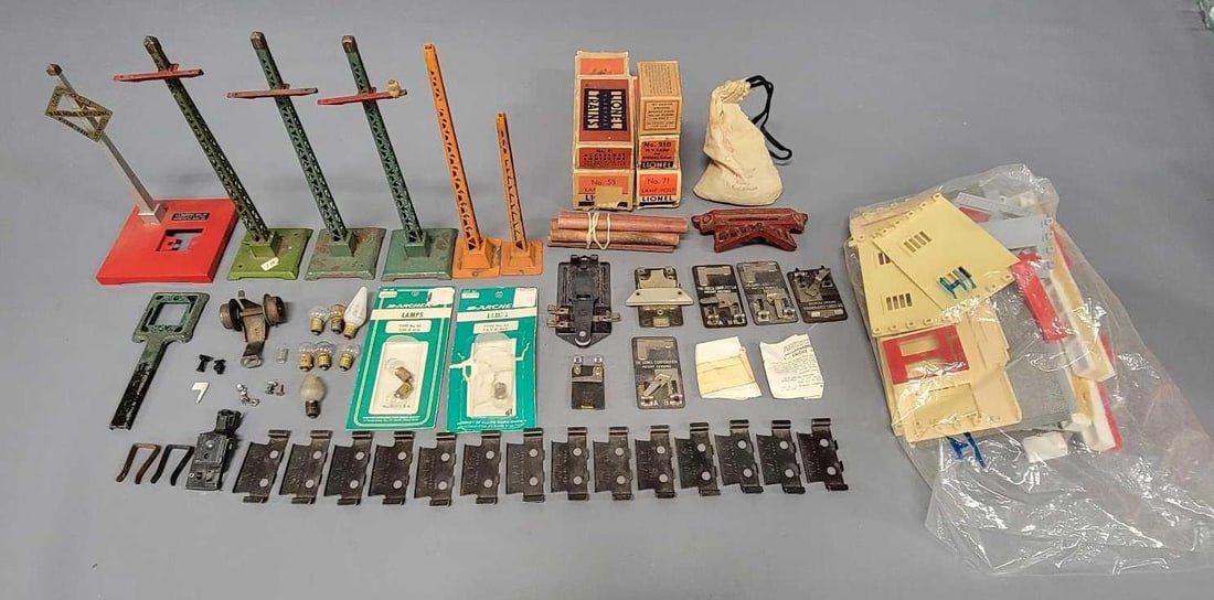 Group of Lionel parts and more: Group of Lionel parts and more to include contactors, a few empty original boxes, a few with items inside, some Plasticville, a few telegraph poles and mores. Sold as-is as seen in the photos with no 