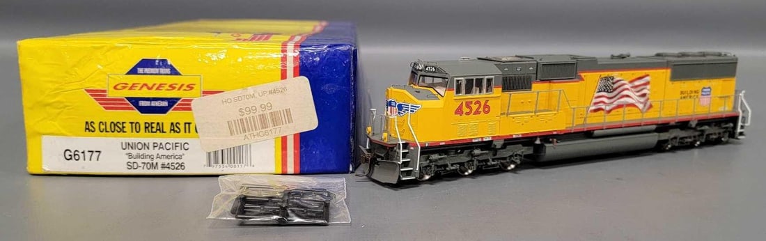 Athearn Genesis HO Union Pacific Building America SD-70M diesel locomotive in OB: Athearn Genesis HO Union Pacific Building America SD-70M diesel locomotive 6-6 cab number 4526 C8-9 stock number G6177 light run time in a poor original box as seen in the photos.
