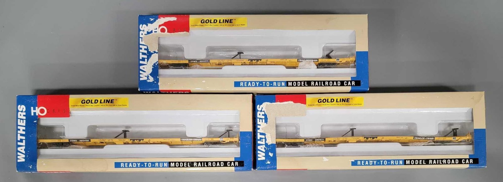 Three Walthers Gold line TTWX All Purpose Flat Cars in OB: Three Walthers Gold line TTWX All Purpose Flat Cars with ACF Hitches. Consists of TTX Old TT Yellow No 991177 stock number 932-40804, Consists of TTX Old TT Yellow No 973458 stock number 932-40805, Co
