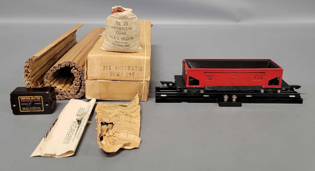 American Flyer S gauge 716 automatic dump car in original box: American Flyer S gauge 716 automatic dump car in original box, car shows moderate run time and is C6 in an excellent original box with track section, button and original instruction sheet in an excell