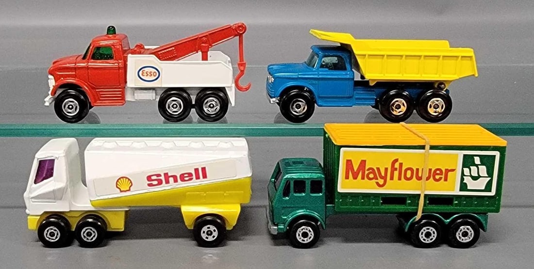 Four Matchbox Superfast Commercial Trucks: Four Matchbox Superfast Commercial Trucks. Consists of No 46 Dumper Truck with black axle clips, No 71 Esso Wreck Truck with red axle clip, No 42 Mercedes Container Truck with Mayflower container, No
