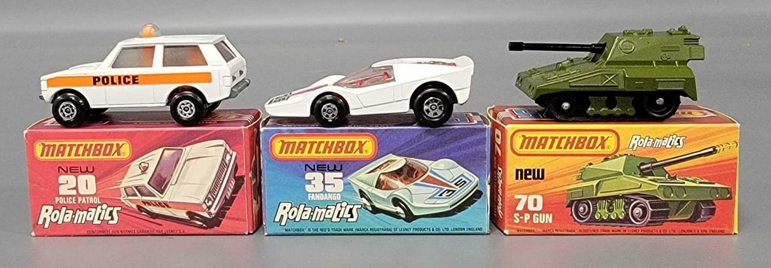 Three Matchbox Rolamatics cars in original box: Three Matchbox Rolamatics cars. Consists of No 20 Police Patrol with Maltese cross wheels, orange stripe, No 35 Fandango with red base, red interior, silver five spoke wheels, No 70 S P Gun with intac