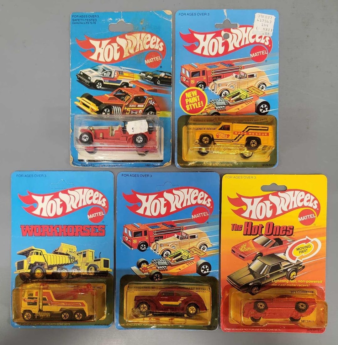 Five Hot Wheels cars and trucks in blister packs: Five Hot Wheels cars and trucks. Consists of Old Number 5 Fire Engine, New Paint Style Race Rescue Emergency Squad,Fat Fendered 40, 80s Corvette with moving part and Rig Wrecker in good to very good b