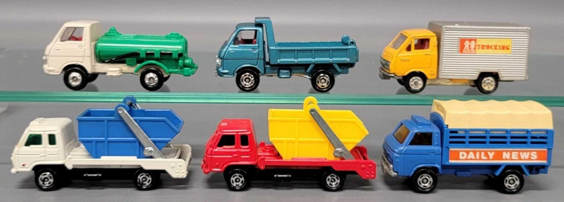 Six Tomica die cast Trucks: Six Tomica Trucks consisting of two Nissan Diesel Condor one is White with Blue one is Red With Yellow, Toyot Hiace box truck missing door, Isuzu Dump Truck, Isuzu Tank Truck and a Isuzu Stake Bed wit