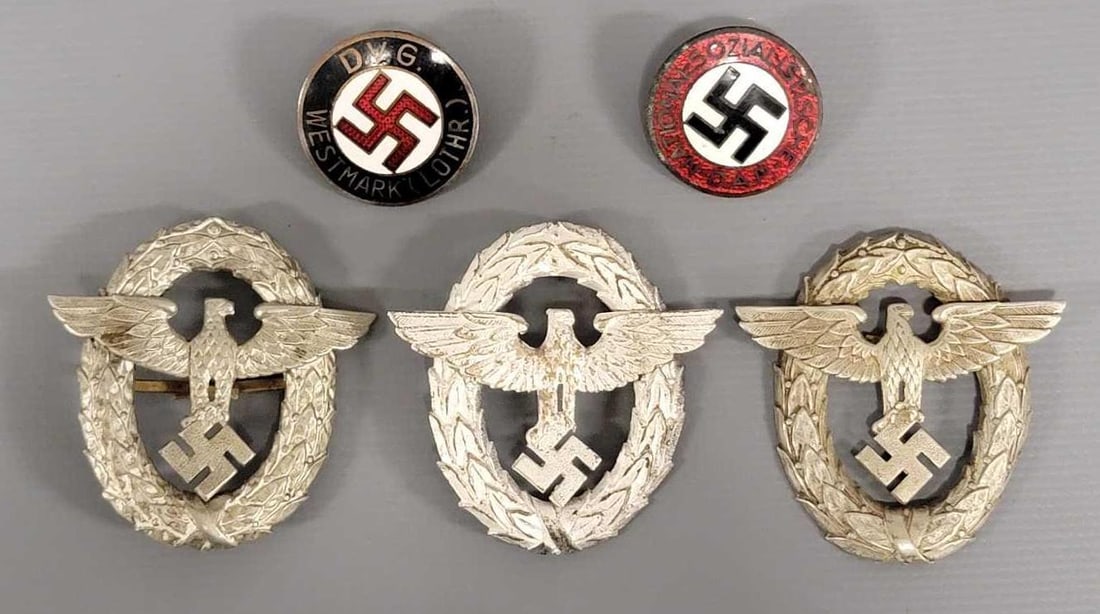Five WWII German Badges and Buttons: Five WWII German Badges and Buttons. Consists of three 1st Pattern Police Visor Cap Eagle Badges and a NSDAP Party Badge with RZM M1/127 and a DVG Westmark Lothr Badge in very good condition as seen i
