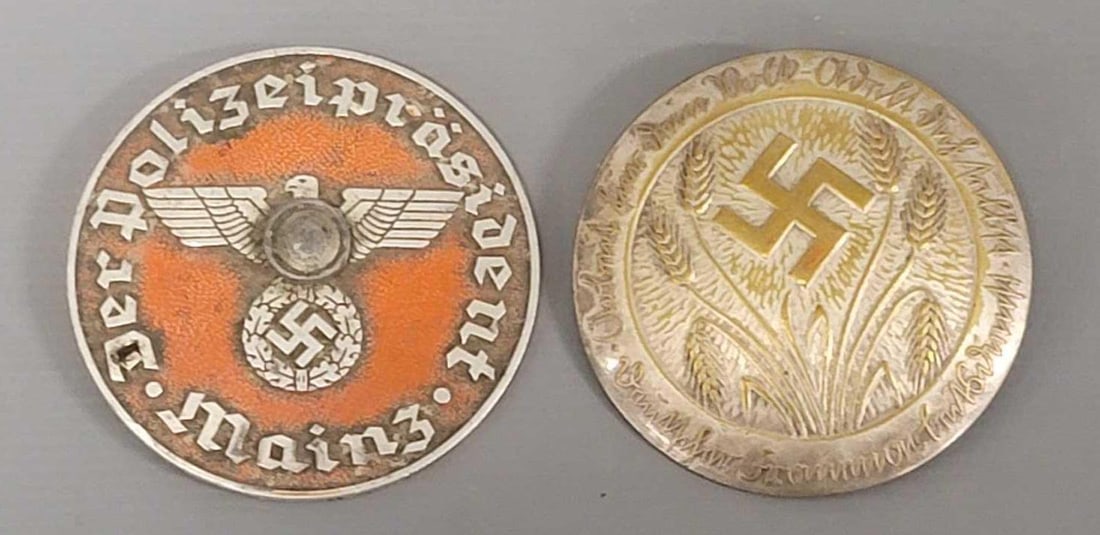 Two WWII German Mainz Police Auto Badge and a Woman's League Badge: Two WWII German Mainz Police Auto Badge and a Woman's League Badge. The Mainz Police Auto Badge has rust along the edge on the back of it in very good condition and a RAD Womans League Badge with 