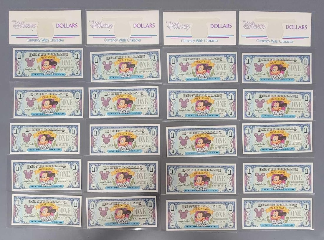 23 Disney Dollars items: 24 Disney Dollars items coansisting of nineteen 65th Anniversary 1993 $1 Mickey bills D series in sequence and four Disney Dollars Character reveal envelopes in near mint to mint condition as seen in