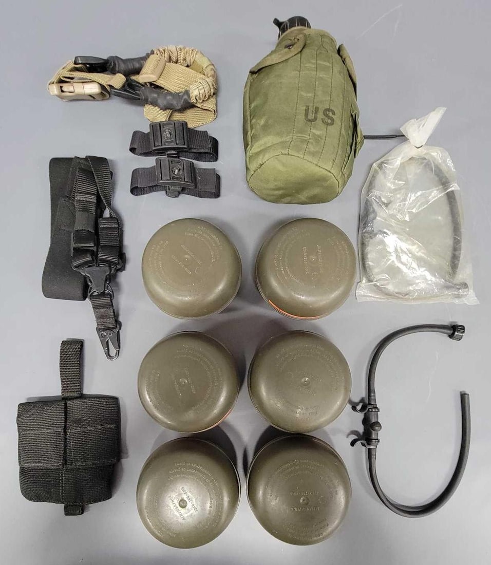 Fourteen military / prepper items: Fourteen military items consisting of two rifle slings, two hydration tubes, 1987 Army Canteen, six German NATO NBC gas mask filters and three more items as seen in the photos.