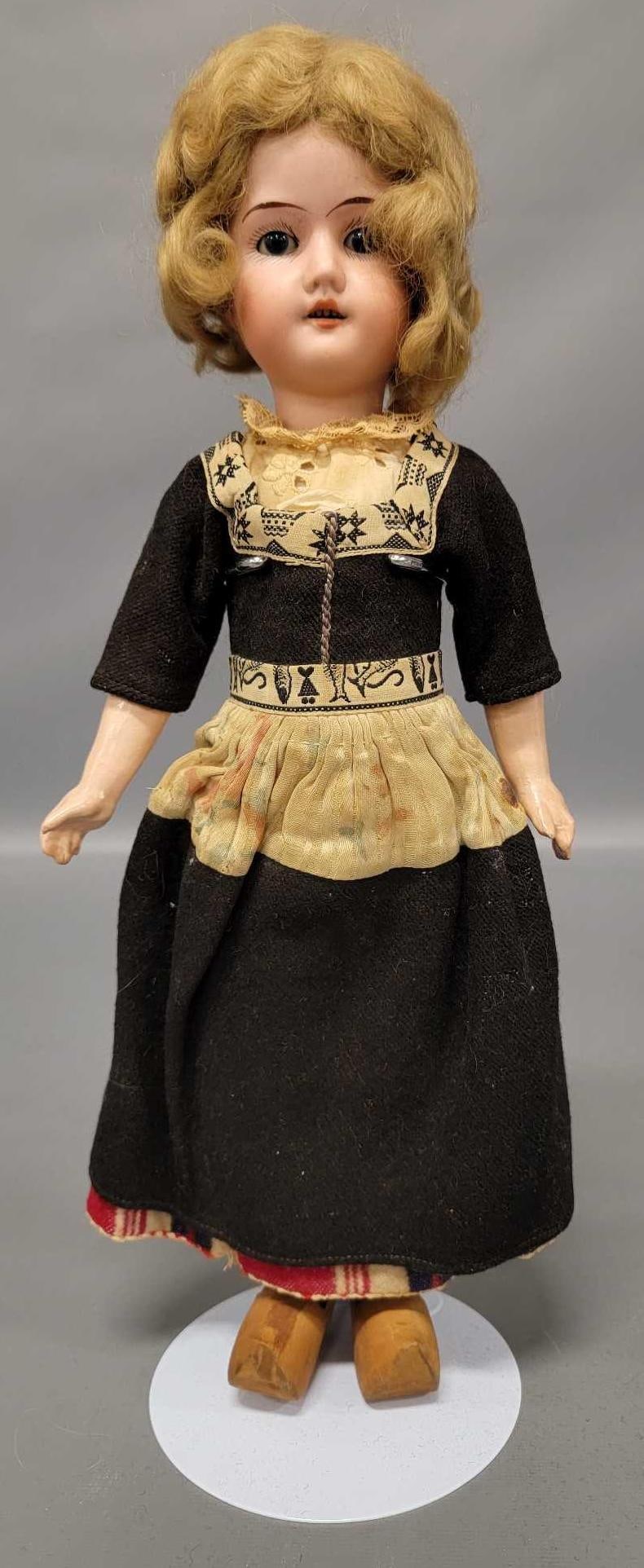 15 inch blue sleepy eys German Bisque head doll: 15 inch blue sleepy eye German Bisque head doll is in very good condition with a loosely strung jointed composition body and original clothes and wig, which is coming off as seen in the photos.