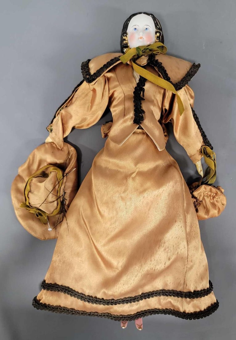 18 inch blue eye China head doll: 18 inch blue eye China head doll unusual snood style is in excellent condition with small chips from the tips of her shoes. Her body, clothes, arms, and legs were done over 55 years ago with her weari