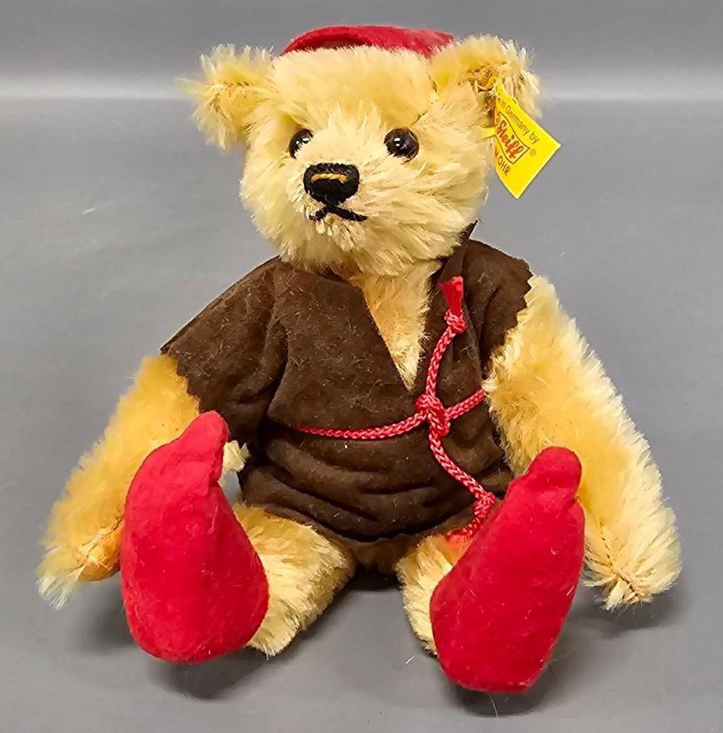 Steiff 7 inch Robin Hood teddy bear: Steiff 7 inch Robin Hood teddy bear 028663 is in excellent condition wearing a red pointed hat, red pointed shoes, and a brown smock with a red rope tied as seen in the photos.