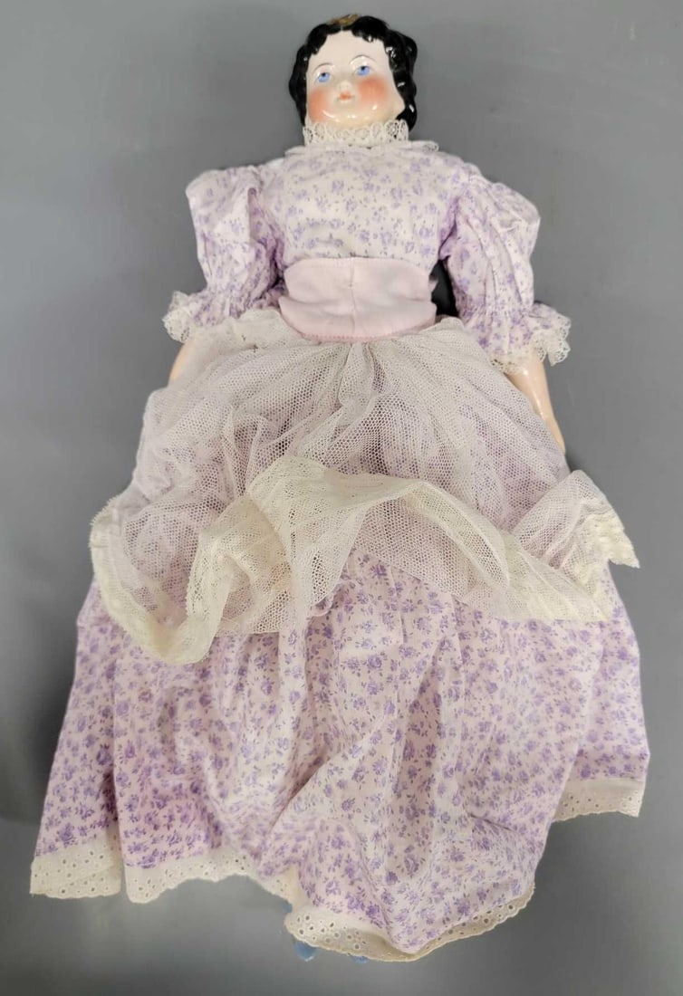 18 inch blue eye China head doll: 18 inch China head doll is in excellent condition with some repairs done on the shoulder plate. Body, arms, and legs are not original. She has an unusual hairstyle with blue headband and bow, and her 