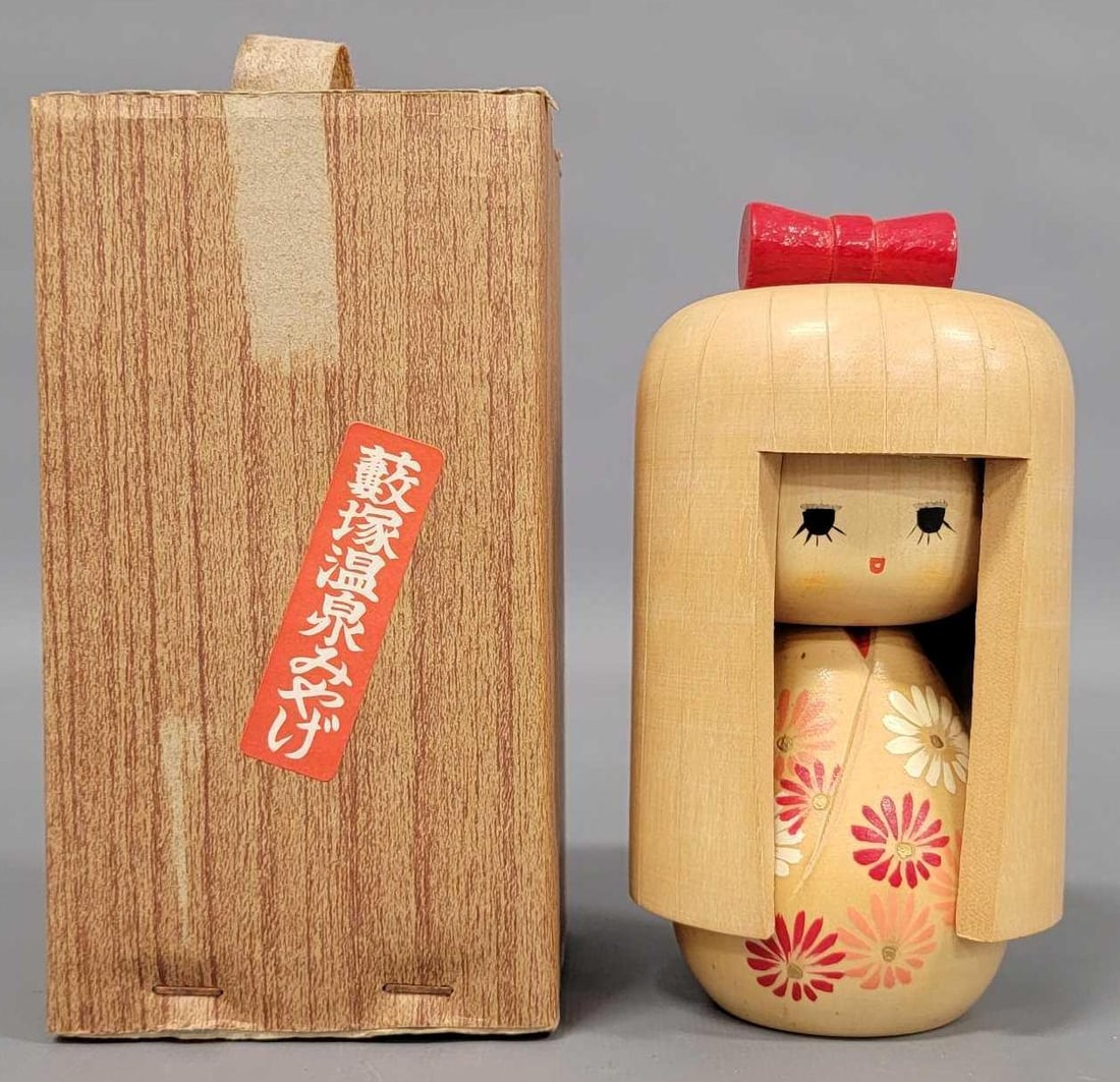 Vintage 5 1/92 inch Japanese Kokeshi wooden doll in original box: Vintage 5 1/2 inch Japanese Kokeshi wooden doll in excellent condition wearing a kimono with red and white flowers and red bow in her long hair and come in original box as seen in the photos.