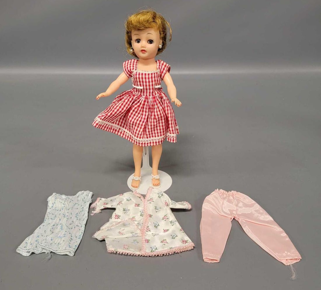 Vintage 10 inch Little Miss Revlon doll with clothes: Vintage 10 inch Little Miss Revlon doll with bra and undies, red and white dress, white with blue flowers dress, pink pants and white with flowers top, and white heels. Doll and clothes are in excelle