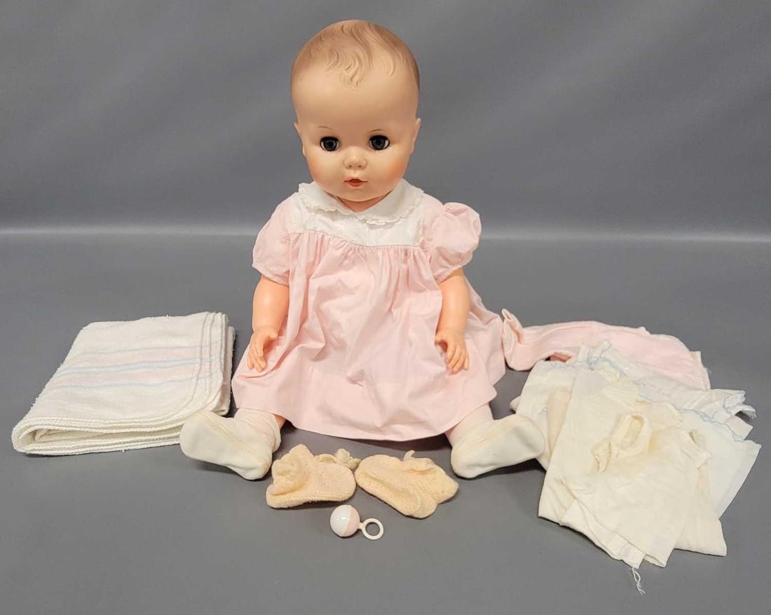 Vintage 24 inch Drink and Wet baby doll: Vintage 24 inch Drink and Wet baby doll is in excellent condition with working arm and leg joints. She is wearing white baby tee, training underpants, pink dress, and white slipper socks. She comes wi