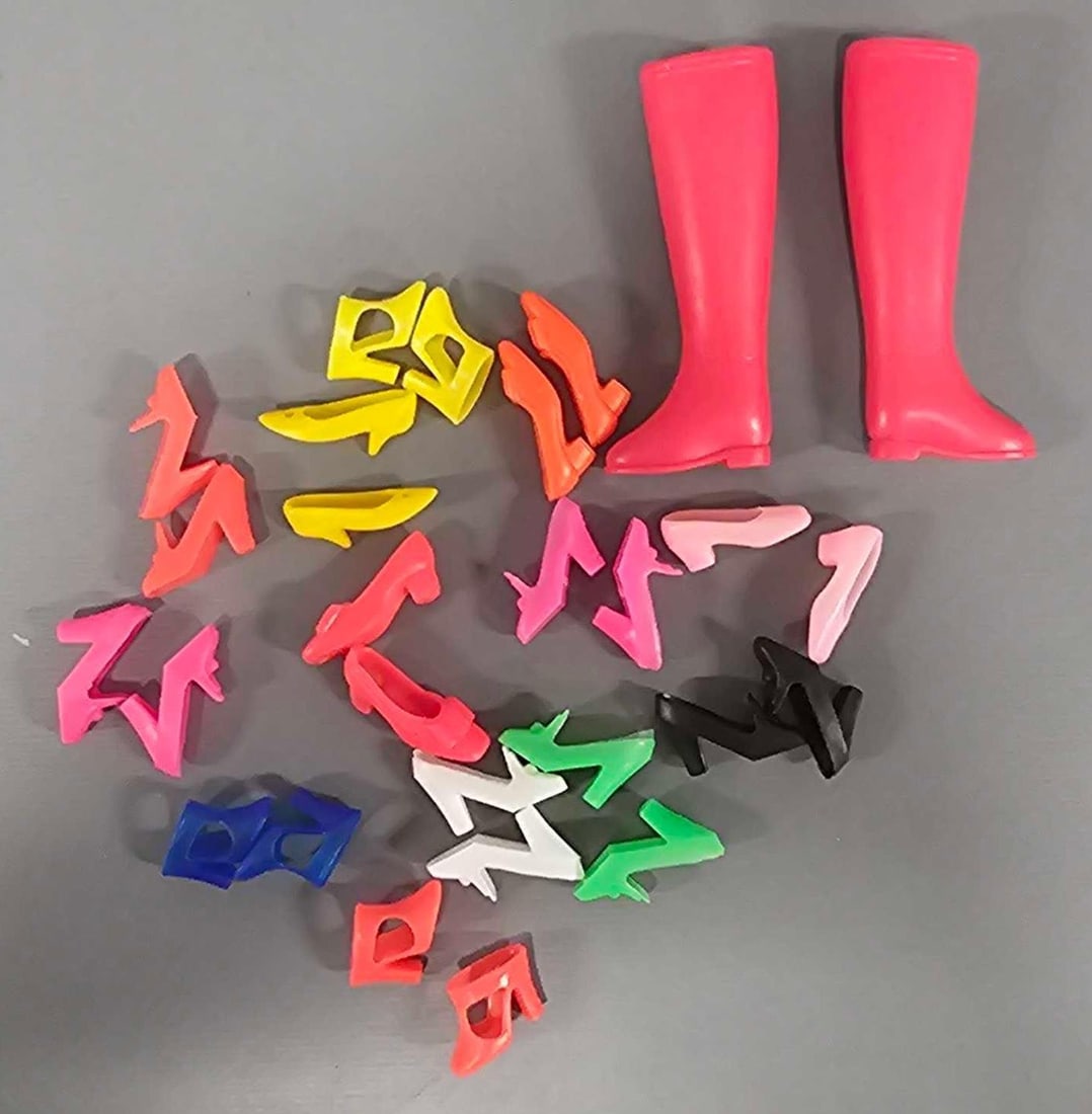 Thirteen pair of vintage Barbie shoes by Mattel: Mixed lot of vintage Barbie shoes in excellent condition. One pair of riding boots and the rest are heels totaling thirteen pair as seen in the photos.