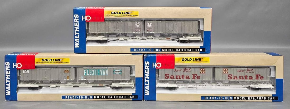 Three Walthers Gold Line Flexi-Van Mark IV Flat Cars with Trailers in original boxes: Three Walthers Gold Line Flexi-Van Mark IV Flat Cars with Trailers. Consists of Pennsylvania stock number 932-41060 road number 9663, New York Central stock number 932-41063 road number 9619 and Santa