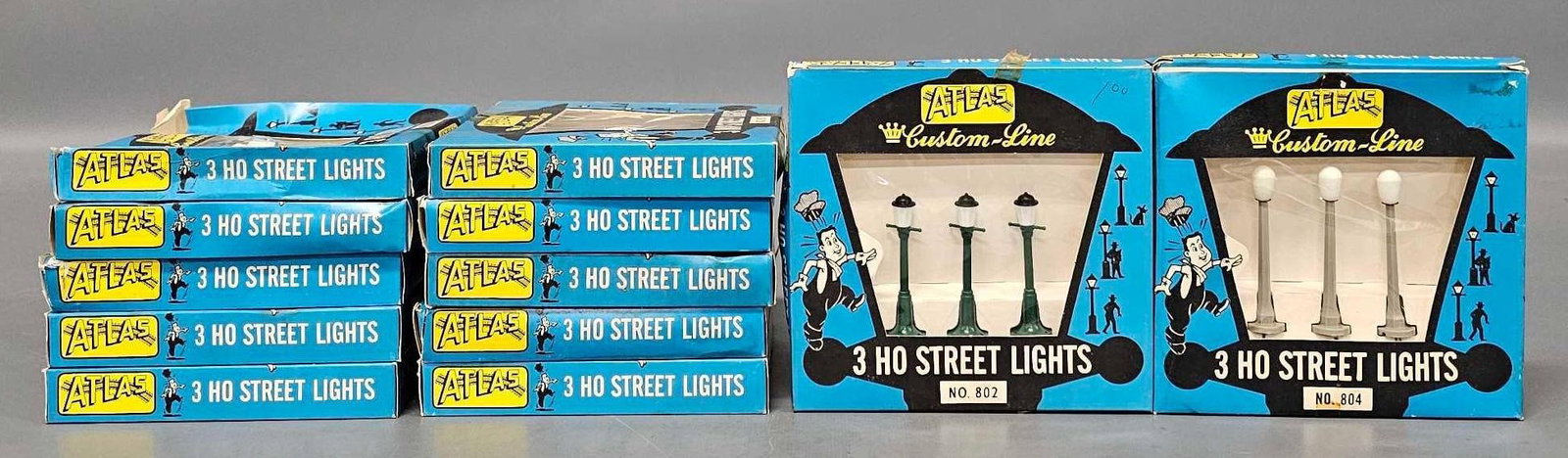 Twelve Atlas HO 3-pack Street Lights in original boxes: Twelve Atlas HO 3-pack Street Lights stock numbers 802 and 804 works on 12V AC or DC current, new and never used in fair to excellent original boxes as seen in the photos.