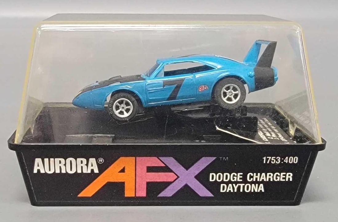 Cubed Aurora AFX 1753 blue charger Daytona slot car: Cubed Aurora AFX 1753 blue charger Daytona slot car. Cube plastic is above average for cleanliness and transparency. Normal run time on the pick up shoes. The paint and finish is crisp and clean with 