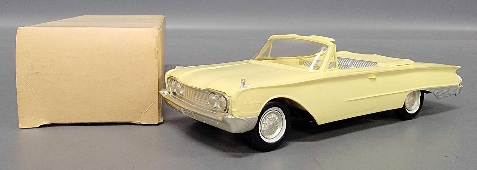 1960 Ford Galaxie Sunliner convertible friction promo car in original box yellow: 1960 Ford Galaxie Sunliner convertible friction promo car in original box in yellow with silver interior detail. The surfaces are fantastic and look untouched but the passengers side fender ornament i
