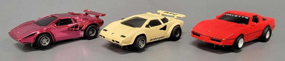 Three Tyco HO slot cars: Three Tyco HO slot cars to include a red Corvette and two Lamborghinis. The white Lamborghini needs a pickup shoe so it will not currently run, the other two run fine and all three are in excellent co