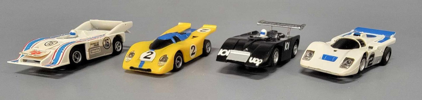 Group of four Aurora AFX slot cars.: Group of four Aurora AFX slot cars. Includes Porsche 917-10k, shadow Can Am, Porsche 917 and Ferrari 512 M. all four bodies are excellent with little use. The lighted yellow 917 chassis head lights wo