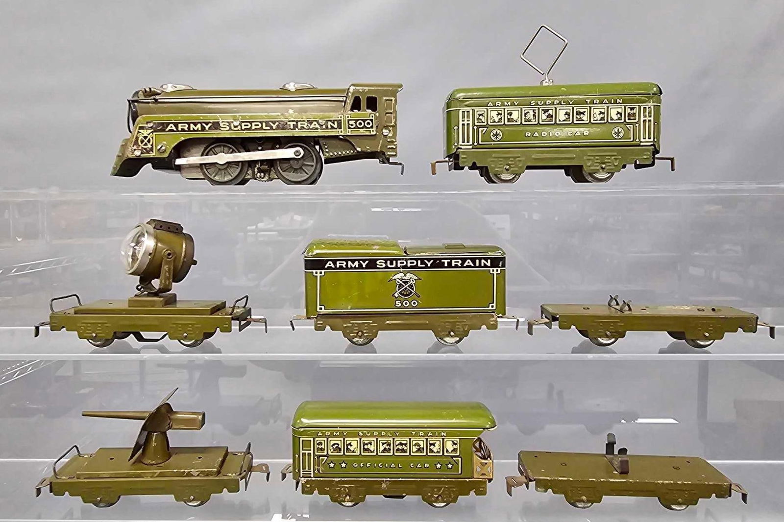 Marx O gauge Army Supply train with 500 steam locomotive: Marx O gauge Army Supply train. Set consists of 500 steam locomotive that has been tested and runs in forward and reverse with headlight, 500 tender, flat car that is missing an airplane, flat car tha