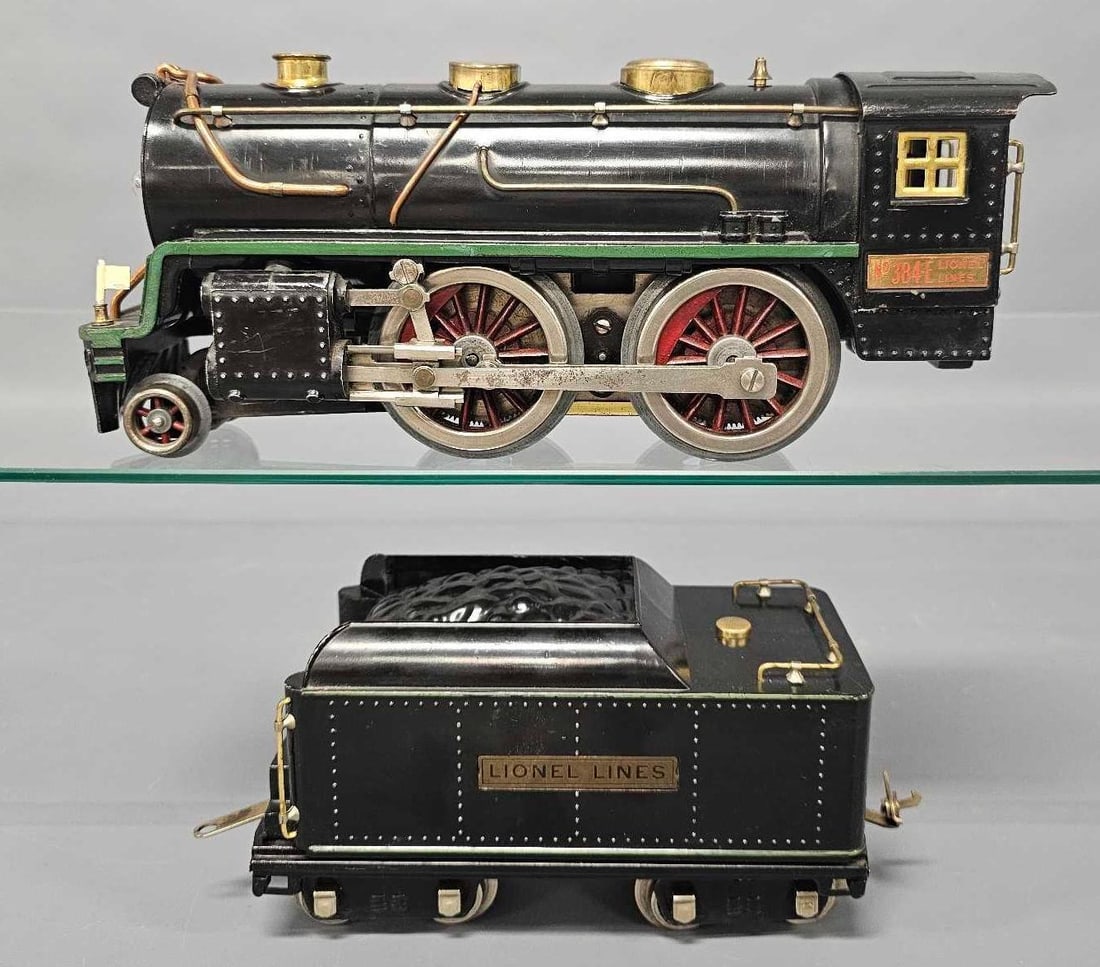 Lionel prewar standard gauge 384E steam locomotive with tender: Lionel prewar standard gauge 384E steam locomotive with tender, both with green stripes. The locomotive had the pilot broken off and reattached. It has been tested and ran beautifully in forward and r