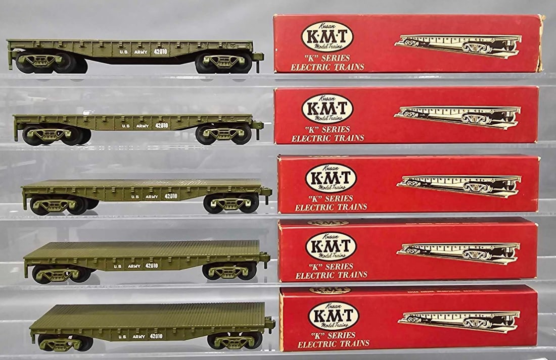 Five Kusan KMT O gauge Army flat cars in original boxes: Five Kusan KMT O gauge Army flat cars in original boxes, the cars are C8-9 in very good to excellent original boxes that are marked ARMY on one end each as seen in the photos.