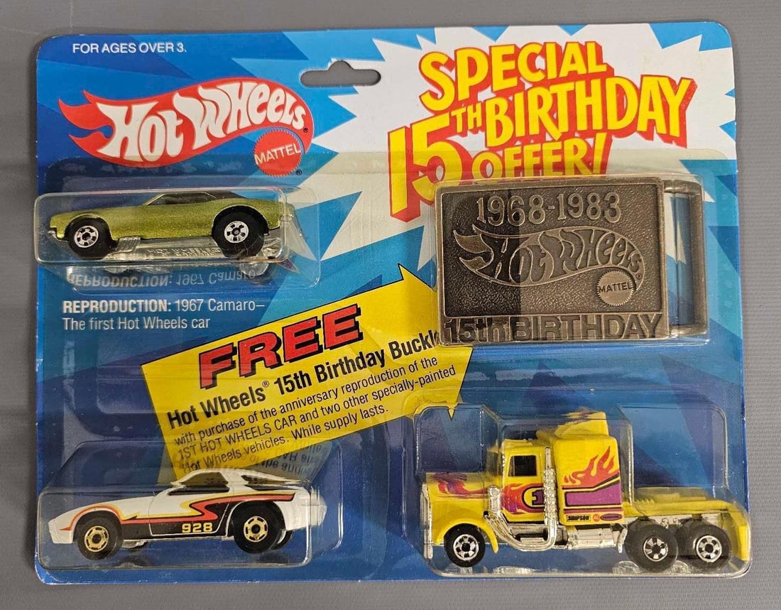 Hot Wheels 15th year birthday offer on blister card with belt buckle: Hot Wheels 15th year birthday offer on blister card with belt buckle. This is a very nice card with a very slightly yellowed blister that includes a 67 Camaro, Porsche P-928, Long Shot semi and a belt