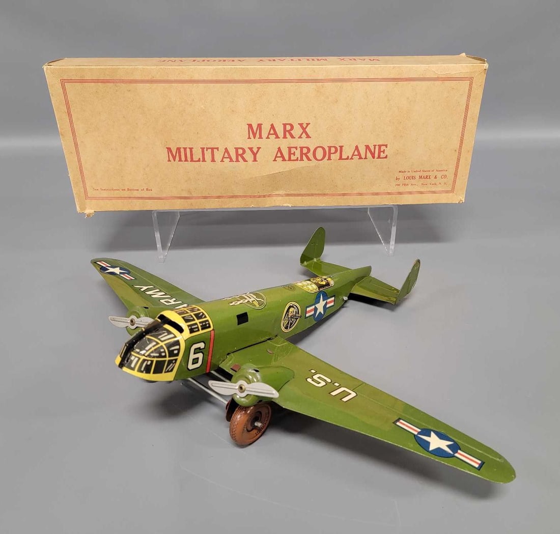 Nice Marx tin lithographed clockwork Military Aeroplane in original box: Nice Marx tin lithographed clockwork Military Aeroplane in original box. The plane is C7 in a complete, excellent original box. The airplane measures 13 1/4 long with an 18 1/4 inch wingspan and works
