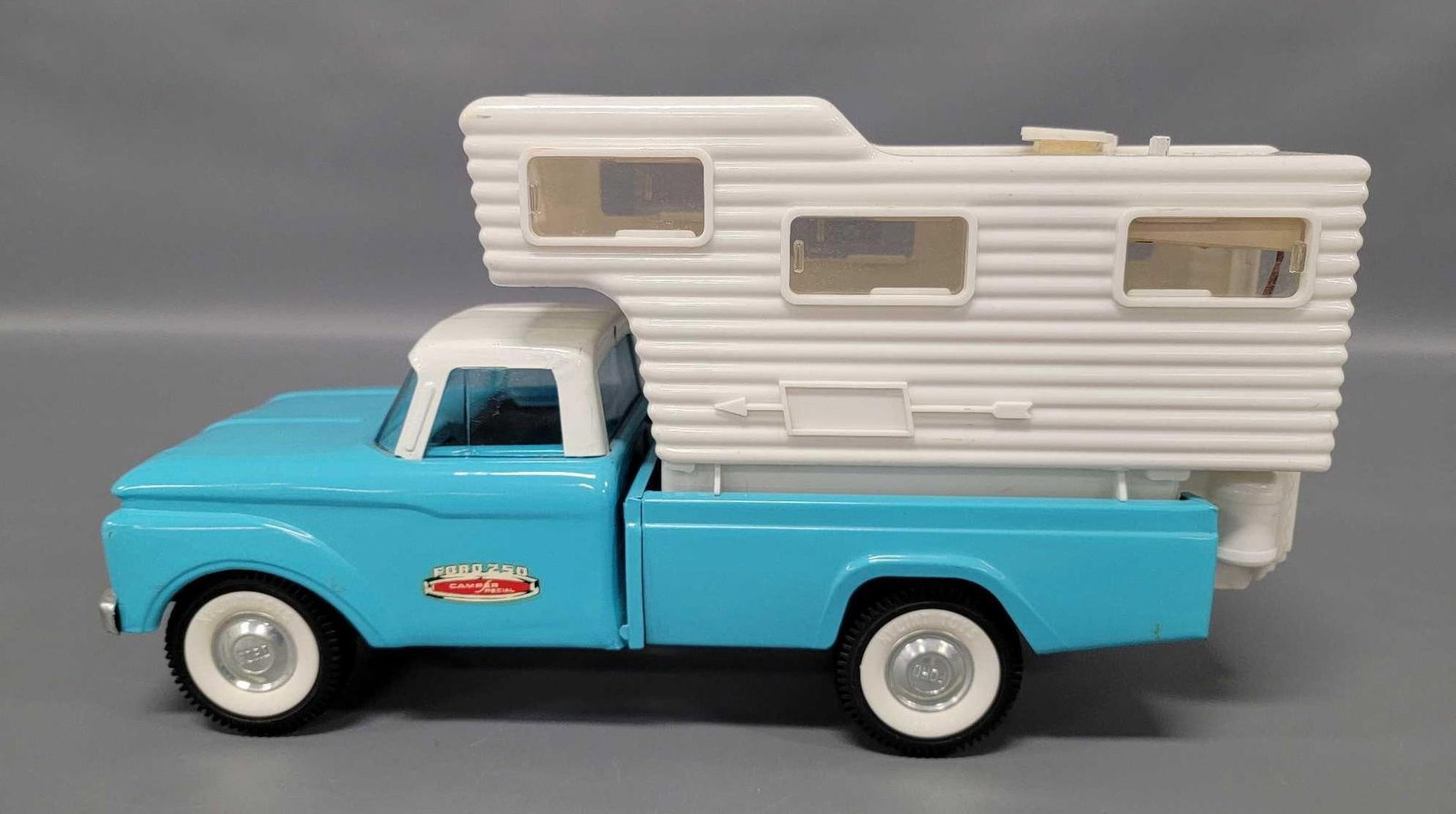Nylint pressed steel Ford F250 pickup with Philco radio camper: Nylint pressed steel Ford F250 pickup with Philco radio camper. The truck is in excellent to near mint condition, the topper is missing the steps and rear door but has great color and is very clean.