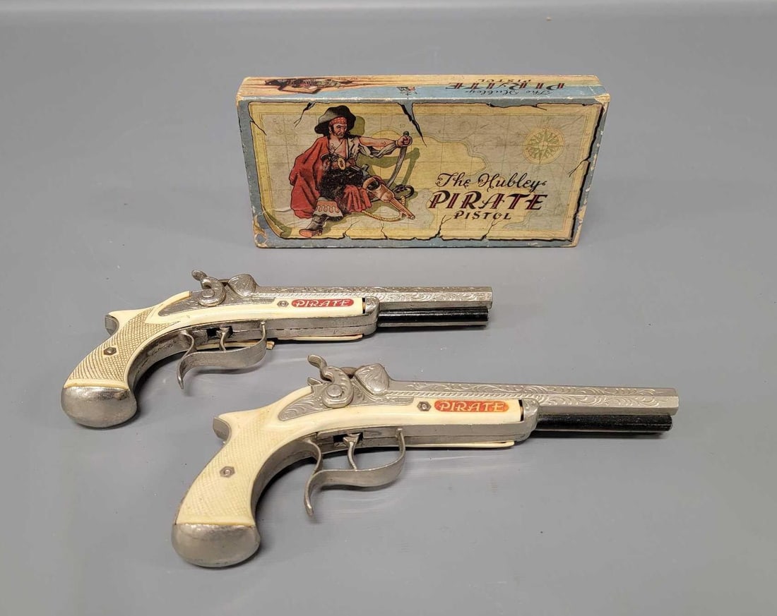 Hubley Pirate cap pistol in original box plus an extra No 265: Hubley Pirate cap pistol in original box, stock number 265, plus an extra. Both examples are identical but one is in excellent plus condition whereas the second is clean but has a broken grip on one s