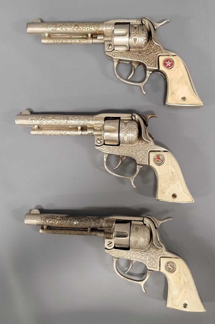 Three Hubley Texan Jr cast iron cap guns: Three Hubley Texan Jr cast iron cap guns, all three are complete with no broken parts, all work properly and two have had caps fired through them, one appears to have never had caps fired. One grip is