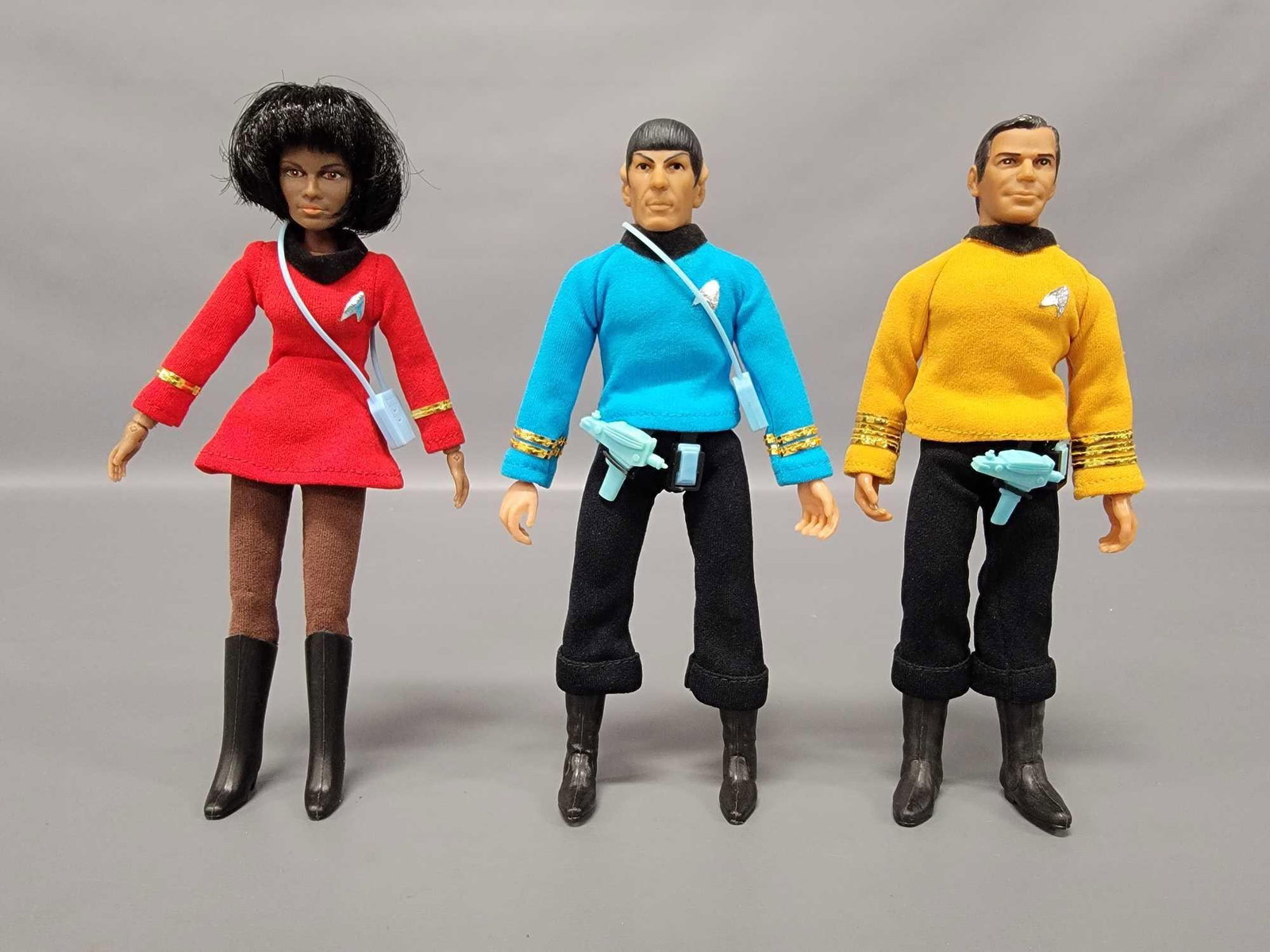 Three high grade Mego Star Trek figures with weapons Kirk Spock Uhura: Three high grade Mego Star Trek figures with weapons to include Captain James T Kirk, Mr Spock and Lieutenant Uhura. All three figures are 100% complete and original with tricorders, phasers and commu